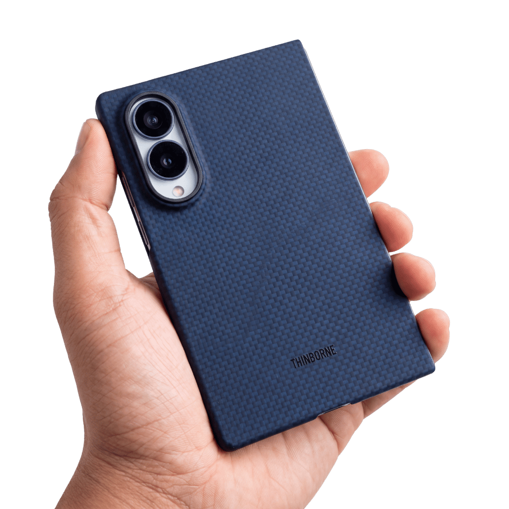 A hand holding a dark blue textured galaxy z fold 8 phone case with a carbon-fiber-like pattern and a visible THINBOONE logo near the bottom, shown against a plain white background.
