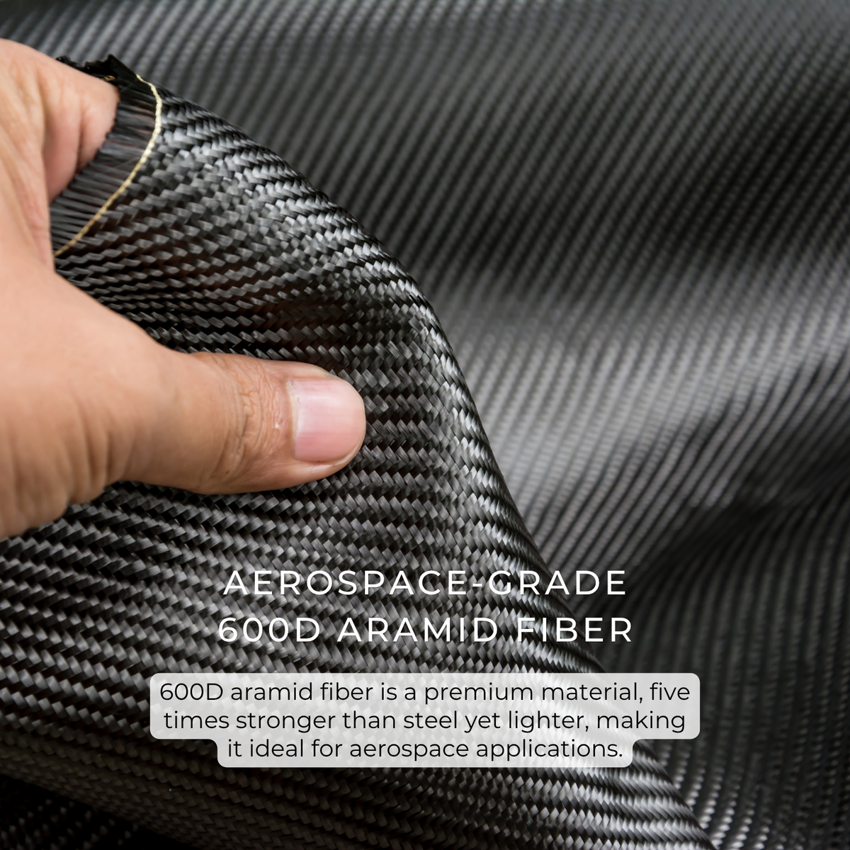 A close-up of a hand holding up a piece of black and gray carbon fiber weave fabric, with text overlay reading 'AEROSPACE-GRADE 600D ARAMID FIBER' and a descriptive paragraph about its strength.