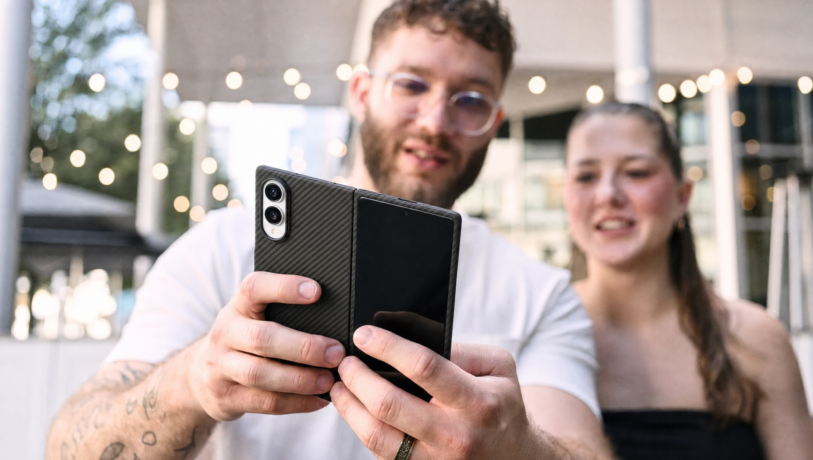 galaxy z fold 8 case held by a man, his girl friend behind him watching with him
