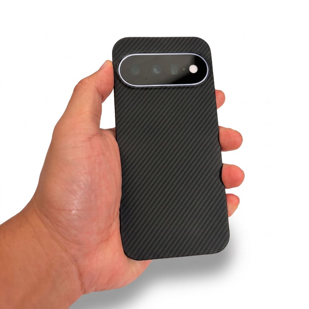 Hand holding Google Pixel 11 fitted with black aramid fiber slim case, real‑life hand‑held demo