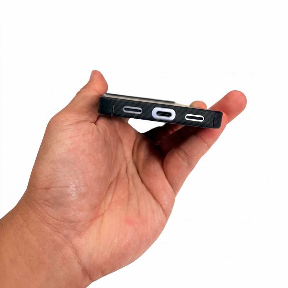 Hand showing bottom USB‑C and speaker cutouts of Pixel 11 aramid fiber thin case
