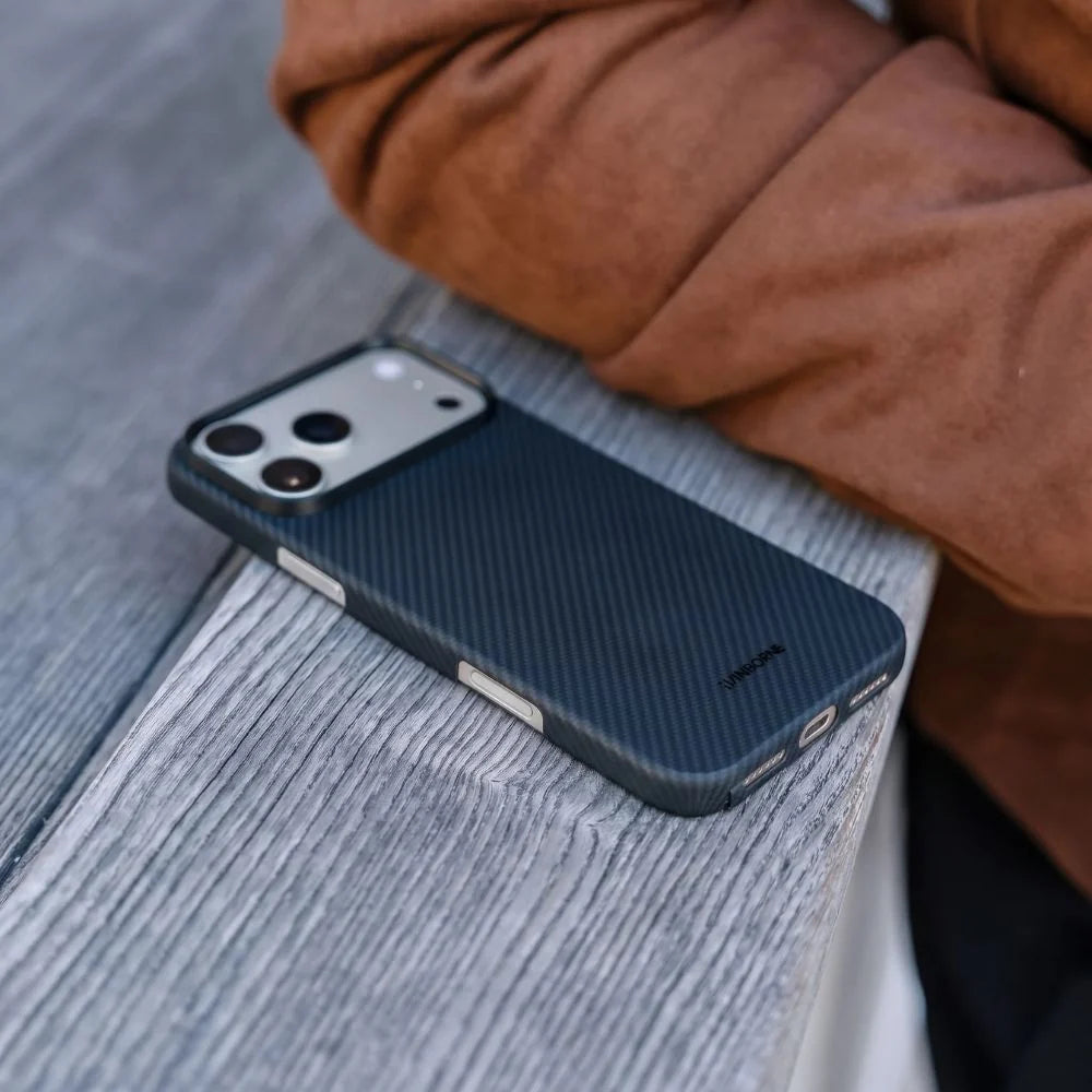 Thinborne iPhone 18 Pro Max aramid fiber slim case laid flat on wooden surface outdoor photo